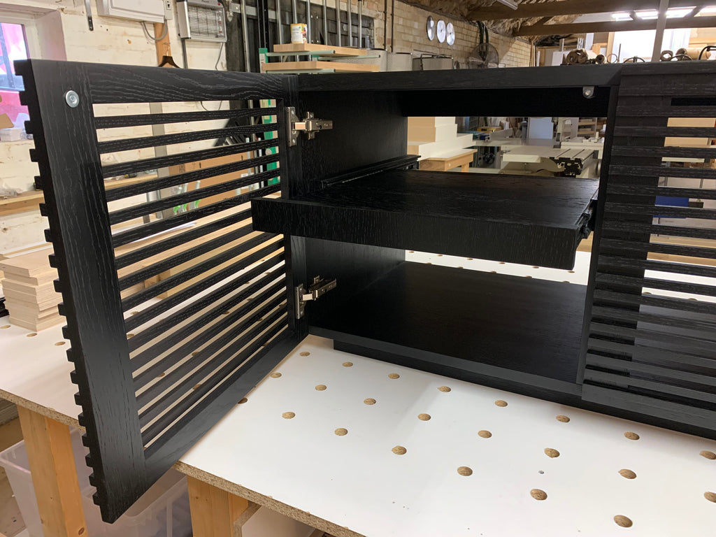 Linear Trio Large AV Cabinet in black wood finish, with optional pull-out draw inside